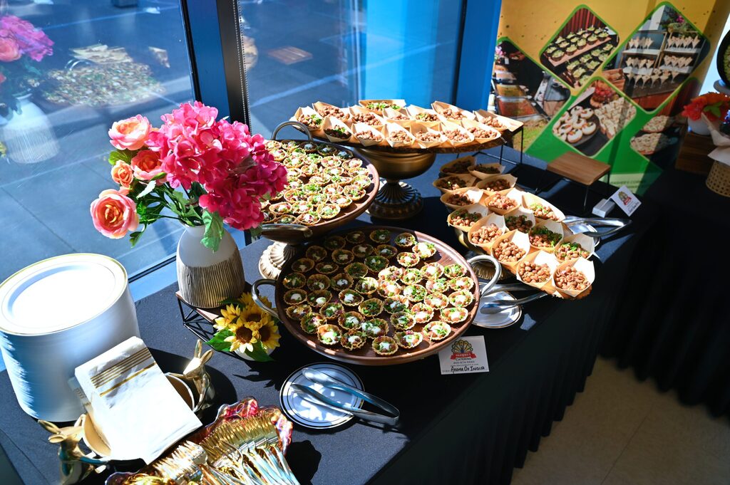 Catering table with flowers, salads and appetiser platters