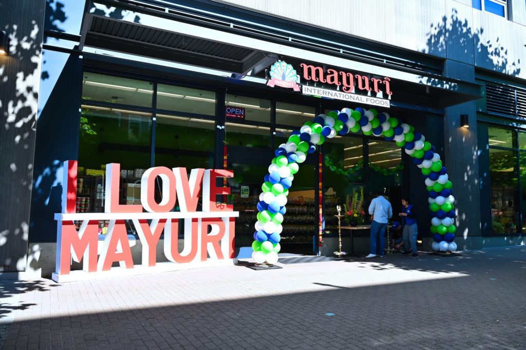 Community gathering outside a Mayuri store