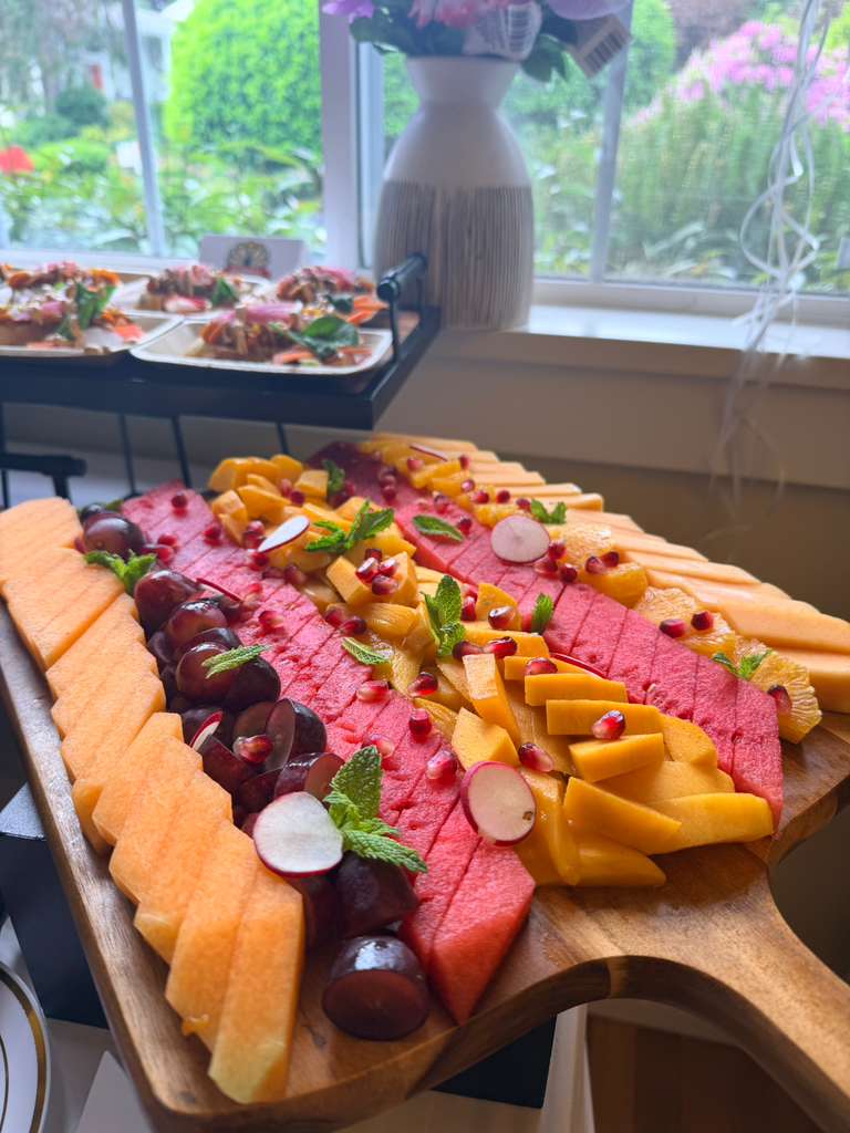 Catering table with flowers, salads and appetiser platters