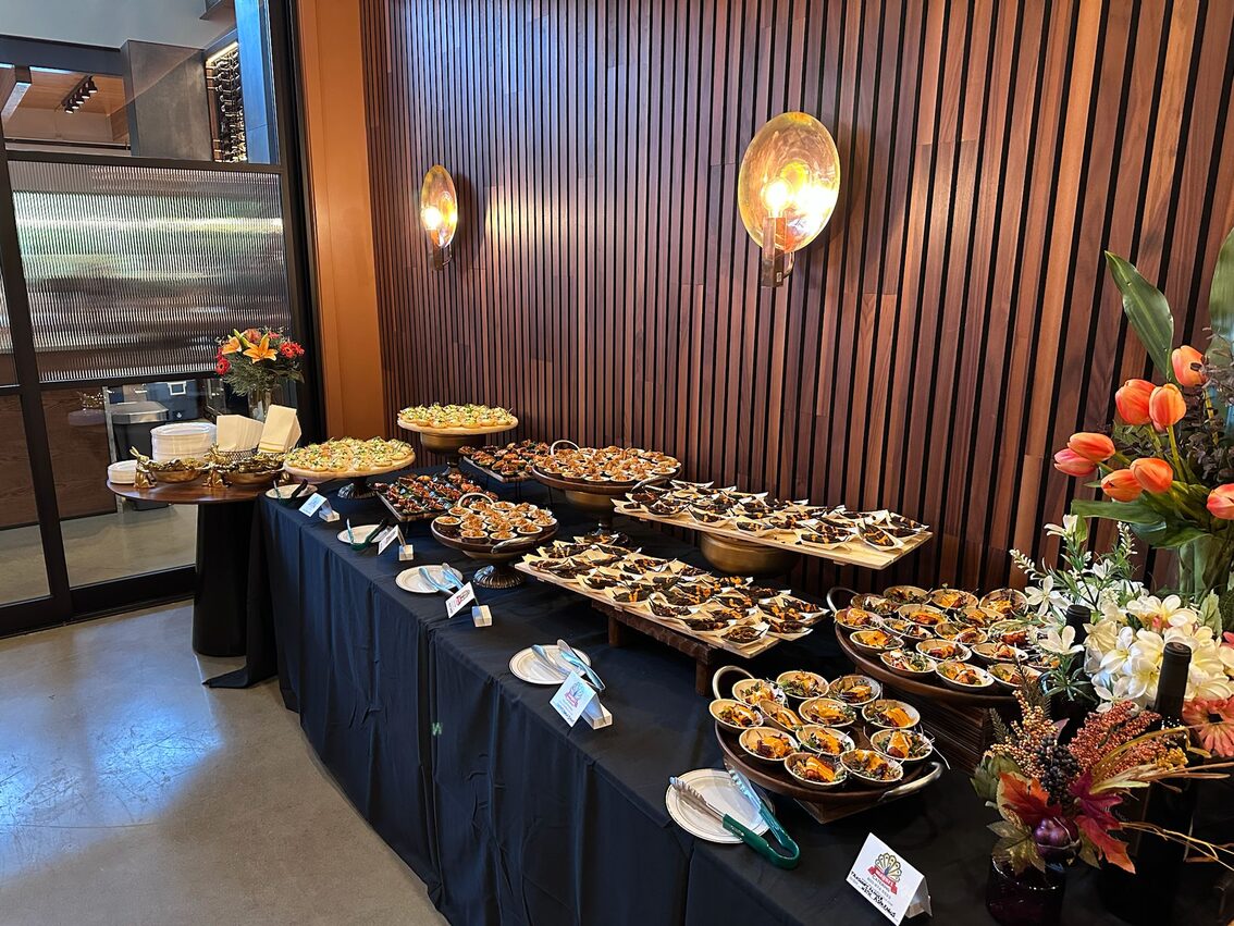 Long buffet table set up by Mayuri catering at a venue